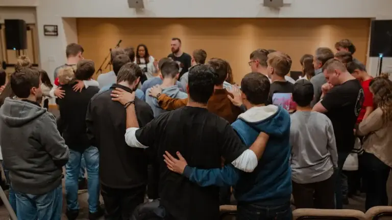 a group of people praying for each other